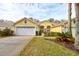 Attractive yellow house with a two-car garage and well-manicured lawn at 3162 Kailani Ct, Ormond Beach, FL 32174