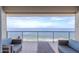 Spacious balcony with ocean view, wicker furniture, and a table at 3425 S Atlantic Ave # 1604, Daytona Beach, FL 32118