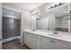 Double vanity bathroom with a large mirror and shower at 424 Luna Bella Ln # 332, New Smyrna Beach, FL 32168