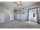 Spacious bedroom with carpet flooring, ceiling fan, and access to a private balcony at 424 Luna Bella Ln # 332, New Smyrna Beach, FL 32168