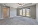Bright bedroom with carpeted floors and sliding glass doors leading to a balcony at 424 Luna Bella Ln # 332, New Smyrna Beach, FL 32168
