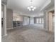 Open concept dining area with a glass table and modern chandelier at 424 Luna Bella Ln # 332, New Smyrna Beach, FL 32168
