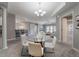 Open concept dining area with a glass table and modern chandelier at 424 Luna Bella Ln # 332, New Smyrna Beach, FL 32168