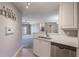 Kitchen with white cabinets, stainless steel dishwasher, and double sink at 424 Luna Bella Ln # 332, New Smyrna Beach, FL 32168