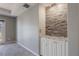 Living room with stone accent wall and access to balcony at 424 Luna Bella Ln # 332, New Smyrna Beach, FL 32168