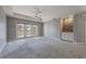 Spacious living room with hardwood floors and access to a balcony at 424 Luna Bella Ln # 332, New Smyrna Beach, FL 32168