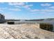 Stone patio area overlooking a lake with fountains at 424 Luna Bella Ln # 332, New Smyrna Beach, FL 32168