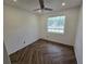Charming bedroom with herringbone floors and a window at 432 Sauls St, Ormond Beach, FL 32174