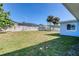 Spacious backyard featuring green grass, trees, and a white fence at 4365 S Peninsula Dr, Ponce Inlet, FL 32127