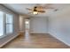 Open-concept living area with wood-look floors, ceiling fan, and seamless flow to other rooms at 4365 S Peninsula Dr, Ponce Inlet, FL 32127