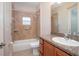 Accessible bathroom with tub and shower, granite countertop, and wood cabinets at 43747 Choctaw St, Deland, FL 32720