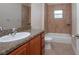 Clean bathroom, featuring a tub and shower, granite countertop, and wood cabinets at 43747 Choctaw St, Deland, FL 32720