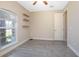 Bedroom with wood-look floors, a ceiling fan, and a window at 43747 Choctaw St, Deland, FL 32720
