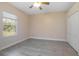 Bright bedroom with wood-look floors, a ceiling fan, and a window at 43747 Choctaw St, Deland, FL 32720