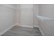 Walk-in closet with wood-look floors and white shelving at 43747 Choctaw St, Deland, FL 32720