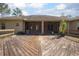 Wooden deck with screened patio and surrounding trees at 43747 Choctaw St, Deland, FL 32720
