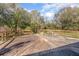 Wooden deck surrounded by lush greenery and a blue sky at 43747 Choctaw St, Deland, FL 32720