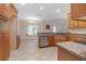Kitchen with breakfast nook, wood cabinets, granite countertops, and stainless steel appliances at 43747 Choctaw St, Deland, FL 32720