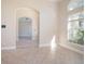 Open living room featuring tile floors and arched doorways at 43747 Choctaw St, Deland, FL 32720