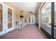Screened-in porch with ceiling fan, tile flooring, and outdoor access at 43747 Choctaw St, Deland, FL 32720