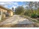 Large side yard with concrete driveway and mature trees at 43747 Choctaw St, Deland, FL 32720