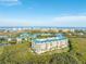 Breathtaking aerial view of the condo complex, showcasing the lush surroundings, ocean views, and stunning architecture at 4672 Riverwalk Village # 8406, Ponce Inlet, FL 32127