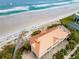 Aerial view of a beachside building with direct access to the sandy shore and ocean waves at 4672 Riverwalk Village # 8406, Ponce Inlet, FL 32127