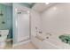 Bright bathroom with tub shower combo and clear glass doors at 4672 Riverwalk Village # 8406, Ponce Inlet, FL 32127
