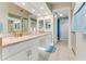 Spacious bathroom featuring double sinks, marble countertops, and ample storage at 4672 Riverwalk Village # 8406, Ponce Inlet, FL 32127