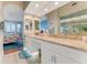 Bright bathroom featuring double sinks, marble countertops and access to bedroom at 4672 Riverwalk Village # 8406, Ponce Inlet, FL 32127