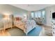 Inviting bedroom with a queen-size bed, seaside décor, and a bay window for natural light and lovely views at 4672 Riverwalk Village # 8406, Ponce Inlet, FL 32127