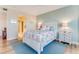 Comfortable bedroom featuring a coastal theme with bright blue accents and light walls at 4672 Riverwalk Village # 8406, Ponce Inlet, FL 32127