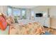 Serene bedroom with a dresser and an inviting bay window for natural light and expansive views at 4672 Riverwalk Village # 8406, Ponce Inlet, FL 32127