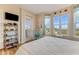 Cozy bedroom featuring a sunny window view and coastal décor, complemented by a comfortable chair at 4672 Riverwalk Village # 8406, Ponce Inlet, FL 32127