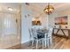 Cozy dining area adjacent to the kitchen, featuring modern lighting and a rustic wood table at 4672 Riverwalk Village # 8406, Ponce Inlet, FL 32127