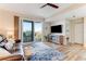 Stylish living room featuring hardwood floors, a modern TV console, comfortable seating, and a balcony view at 4672 Riverwalk Village # 8406, Ponce Inlet, FL 32127