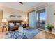 Cozy living room with a leather sofa, patterned rug, and sliding glass doors leading to a balcony at 4672 Riverwalk Village # 8406, Ponce Inlet, FL 32127
