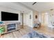 Bright living room with a modern fireplace and media center, with light hardwood flooring and coastal accents at 4672 Riverwalk Village # 8406, Ponce Inlet, FL 32127