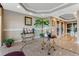 Lobby area with neutral décor, stylish tables, and floral arrangements near the elevators at 4672 Riverwalk Village # 8406, Ponce Inlet, FL 32127