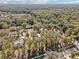 An aerial view reveals this home nestled in a tree-lined suburban street in a peaceful community at 475 W Main St, Lake Helen, FL 32744