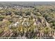 This aerial view highlights a home nestled among lush trees in a quiet residential neighborhood at 475 W Main St, Lake Helen, FL 32744