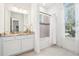 Bright bathroom features a single vanity with marble countertops and a shower-tub combo at 475 W Main St, Lake Helen, FL 32744