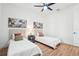 Bright bedroom with two twin beds, wood floors and ceiling fan at 475 W Main St, Lake Helen, FL 32744