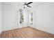 This bright bedroom features wood-look tile flooring and two large windows with curtains at 475 W Main St, Lake Helen, FL 32744