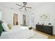 Bedroom with dresser and access to bathroom and patio at 475 W Main St, Lake Helen, FL 32744
