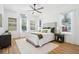 Airy bedroom featuring large windows, neutral decor, a ceiling fan, and wood-look floors at 475 W Main St, Lake Helen, FL 32744