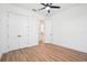 A spacious bedroom features wood-look tile flooring, ceiling fan, and double door closet at 475 W Main St, Lake Helen, FL 32744
