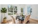 Elegant dining area with modern furniture, large windows, and serene outdoor views at 475 W Main St, Lake Helen, FL 32744