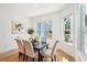 Bright dining room with large windows, modern decor, and wood floors at 475 W Main St, Lake Helen, FL 32744