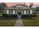 Beautiful 2-story house with light blue siding, metal roof, and landscaped lawn at 475 W Main St, Lake Helen, FL 32744